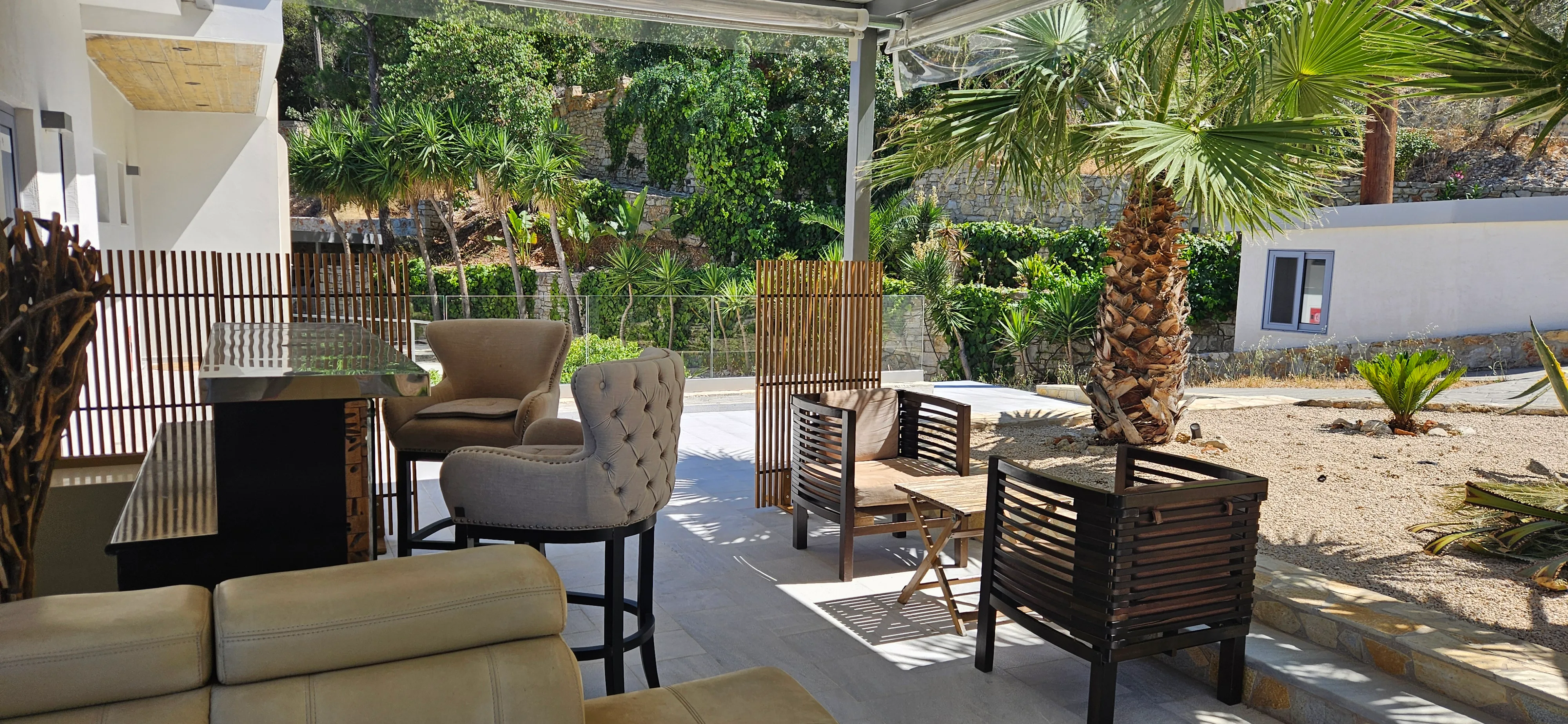 Outdoor lounge seating shaded by a pergola