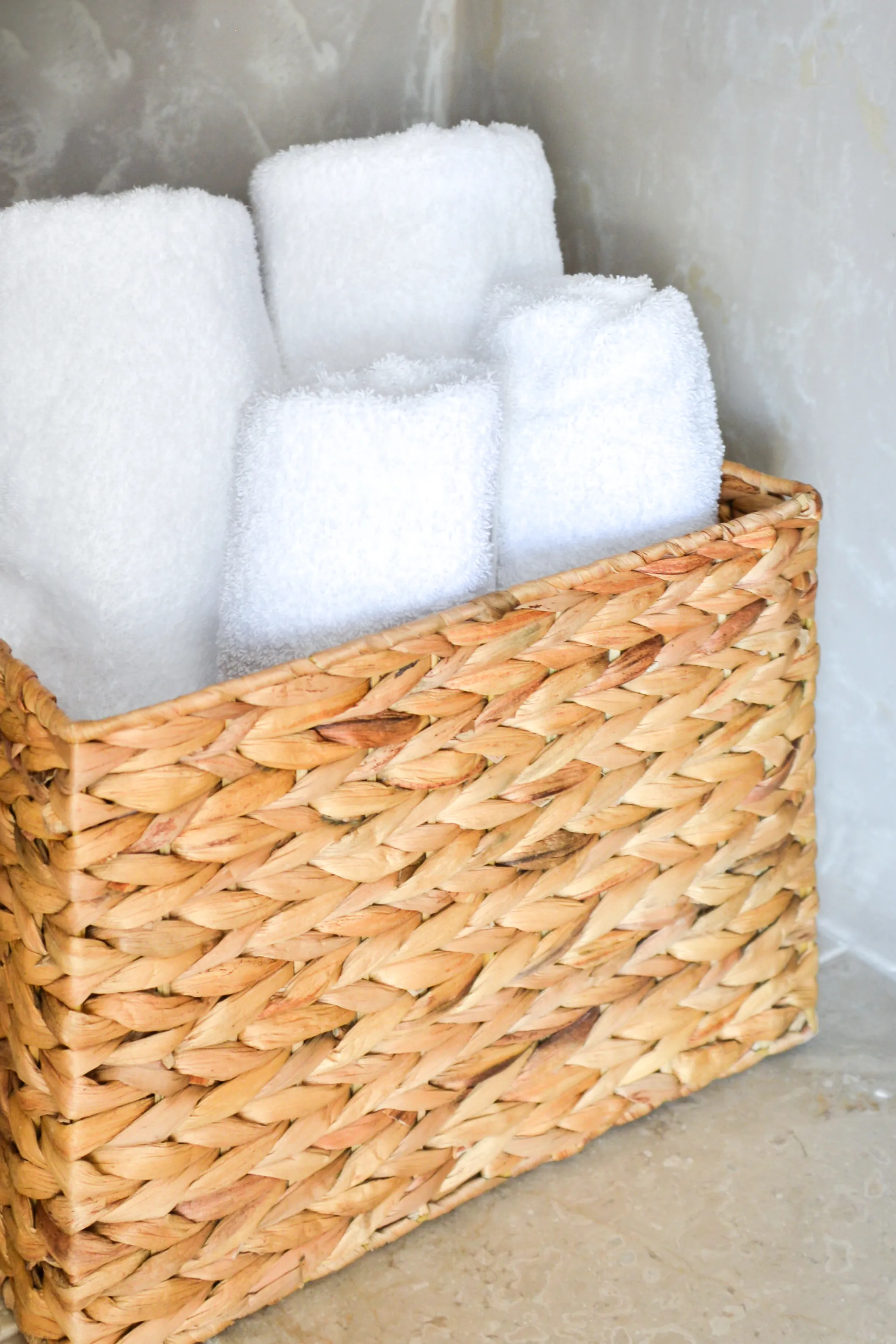 White towels in a woven basket