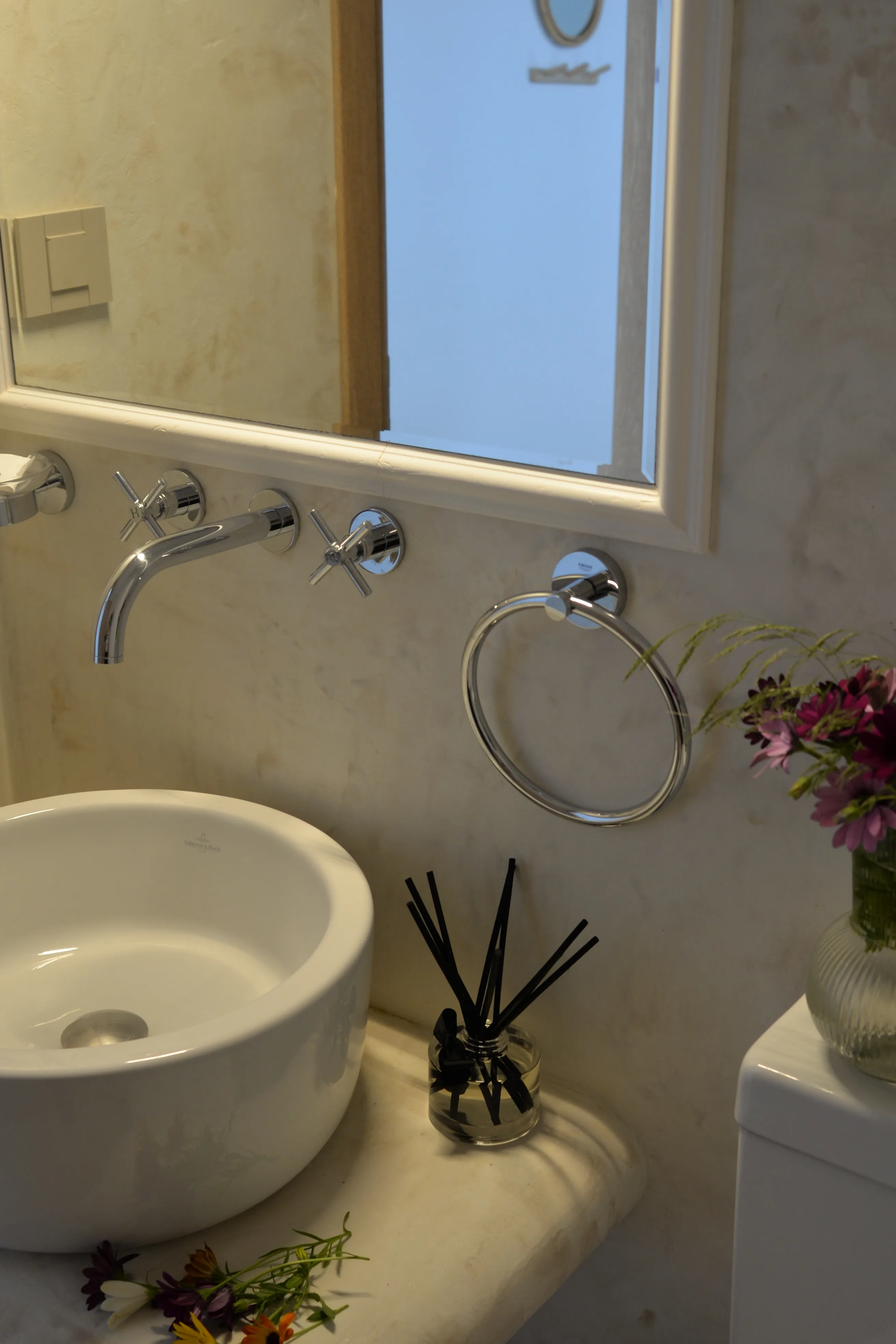 Stone basin and polished fittings in a bathroom